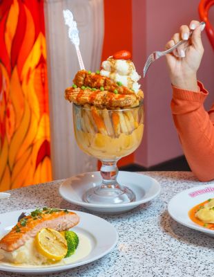 A Glass Of Wine And A Plate Of Food On A Table