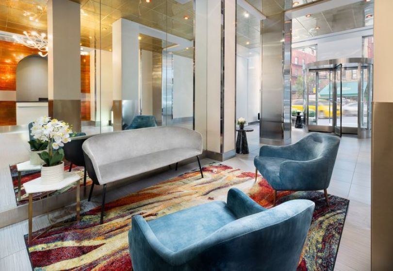 A Room With A Couch And Chairs