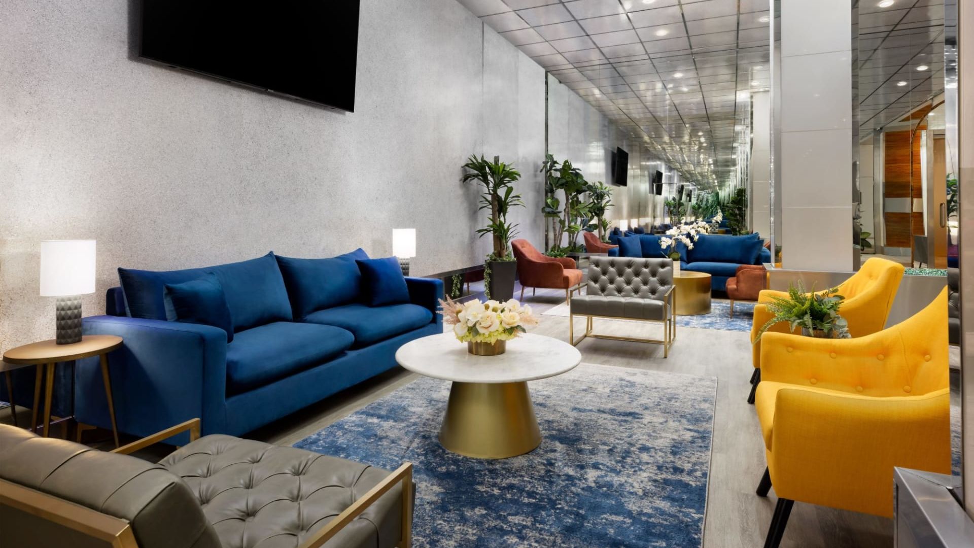 A Room With Blue Couches And A Tv