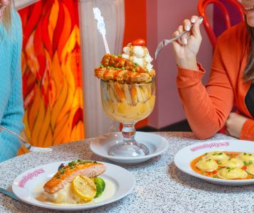 A Glass Of Wine And A Plate Of Food On A Table