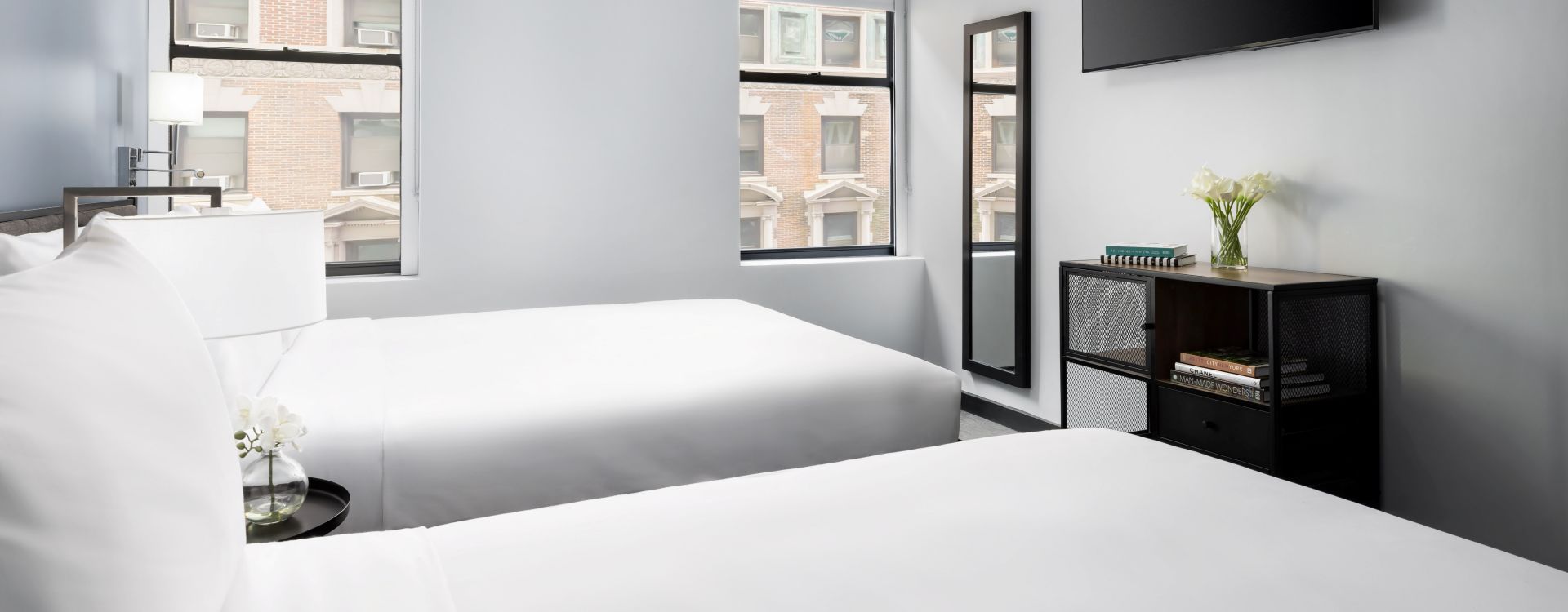 A Bedroom With A Tv And A Bed