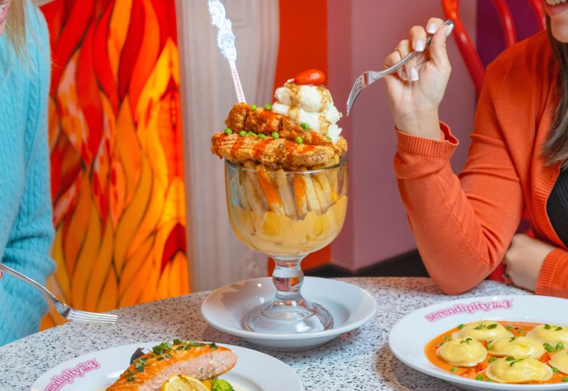 A Glass Of Wine And A Plate Of Food On A Table